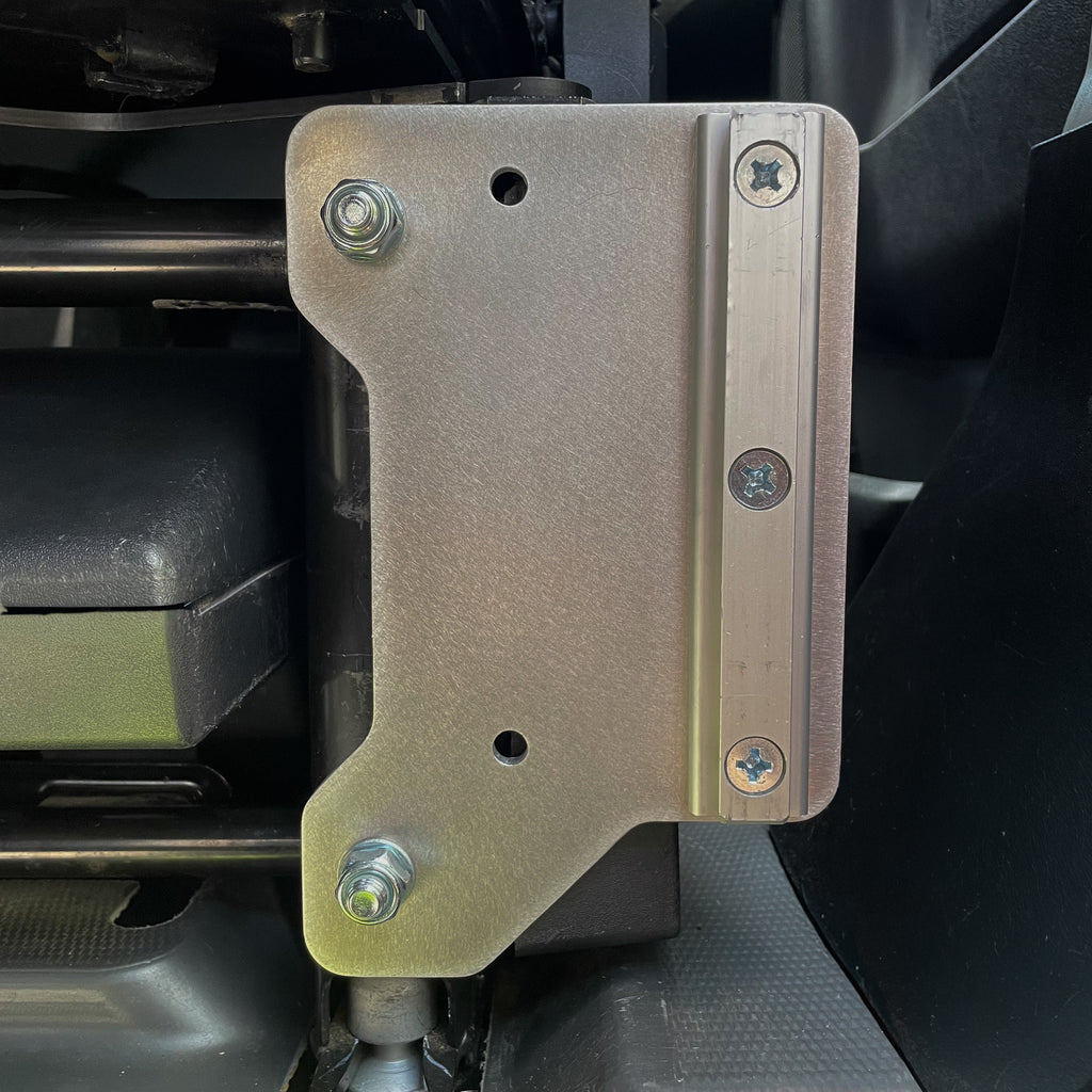 Ram ProMaster Lagun table mount bracket installed on factory seat base, reversible aluminum bracket showing alternate face mounting position without table arm